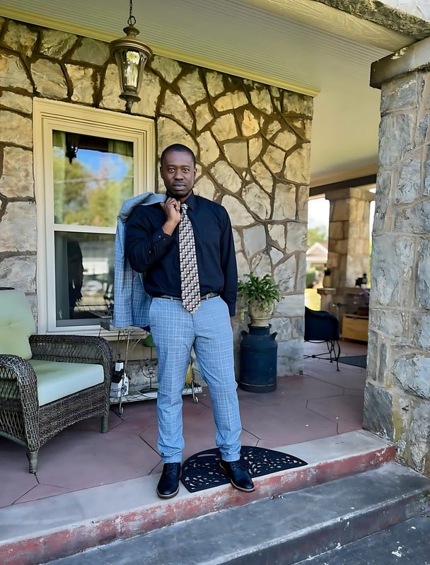 Marquise Scott standing on a stone-front porch
